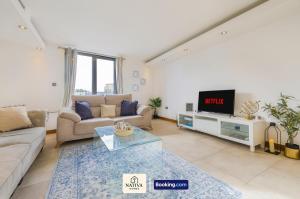 a living room with a couch and a tv at Spacious 2BR, 2BA Apt By Nativa Homes Short Lets & Serviced Accommodation Harrow With Fast WiFi, Kitchen in Harrow