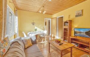 a living room with a couch and a table at Ferienhaus Boitzenburger Land in Rosenow