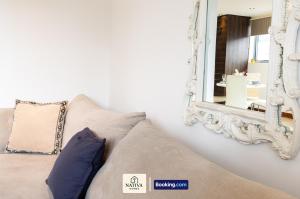 a couch with a mirror on the wall at Spacious 2BR, 2BA Apt By Nativa Homes Short Lets & Serviced Accommodation Harrow With Fast WiFi, Kitchen in Harrow