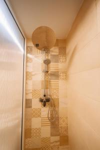 a shower with a shower head in a bathroom at Relax Family ApartHotel - Signature Residence in Ouarzazate