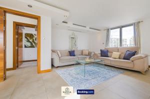 a living room with two couches and a glass table at Spacious 2BR, 2BA Apt By Nativa Homes Short Lets & Serviced Accommodation Harrow With Fast WiFi, Kitchen in Harrow