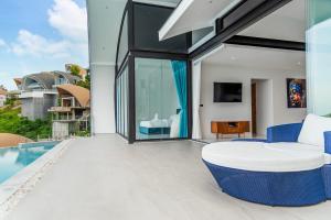 an outdoor patio with a bed and a pool at Sea View Chaweng Noi Villa Luxury in Chaweng Noi Beach