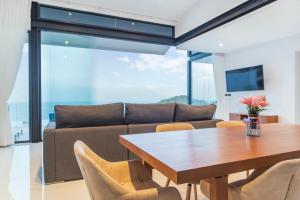 a living room with a table and a couch at Sea View Chaweng Noi Villa Luxury in Chaweng Noi Beach