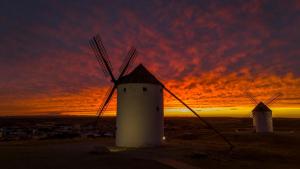 a group of windmills with a sunset in the background at Chicote Rural in Mota del Cuervo +9 photos