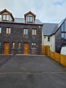 a large brick house with a parking lot at Luxury 3 Bedroom Welsh Valley Retreat With Superfast Wifi in Tredegar