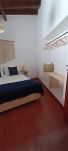 a bedroom with a bed in a white room at Casa da Pedra in Pedrógão +24 photos