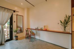 a room with a bar with two chairs and a window at UNLTD Hotel Siargao in General Luna +30 photos