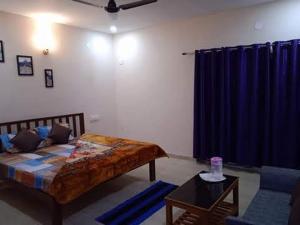 a bedroom with a bed and a blue curtain at The Tiger's Hill Retreat in Lagma