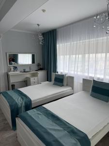 a bedroom with two beds and a window at Vip House Hotel in Astana +121 photos