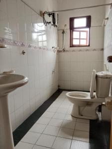 a bathroom with a toilet and a sink at Urenium Matara in Matara