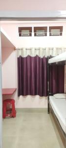 a room with two bunk beds and a curtain at Backpackers' Haven in Guwahati