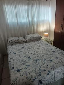 a bedroom with a bed with a blue and white comforter at Anker Guesthouse in Philippolis