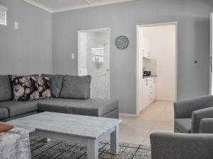 a living room with a couch and a table at Splendid Village in Beaufort West