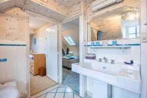 a bathroom with a sink and a mirror at Gîte de L'Ouvroux-25min Puy Du Fou in Montournais +33 photos