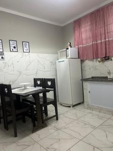 a kitchen with a table and a refrigerator at Flórida in São Carlos +37 photos