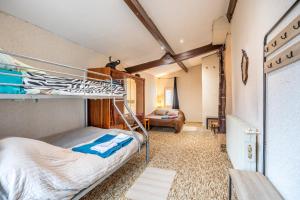 a bedroom with a bunk bed and a living room at Gîte de L'Ouvroux-25min Puy Du Fou in Montournais