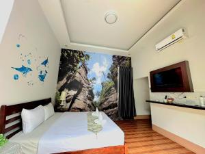 a bedroom with a large painting on the wall at Cocoloco Pool Villa Ao nang in Ban Khlong Son +20 photos
