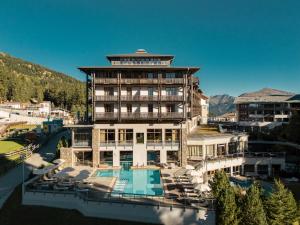 a large building with a pool and a resort at Falkensteiner Aktiv & Familienhotel Cristallo Superior in Katschberghöhe