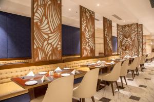 une rangée de tables et de chaises dans un restaurant dans l'établissement Hotel Lumbini Heritage, à Rummindei 19 autres photos