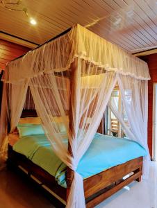 a bedroom with a canopy bed with mosquito nets at Hidden hi gust ella in Ella