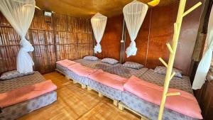 a room with three beds in a wooden cabin at Akimebonphuresort in Ban San Pu Loei (2)