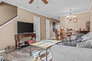 a living room with a couch and a table at Woodstone Retreat right next to UGA golf course in Athens