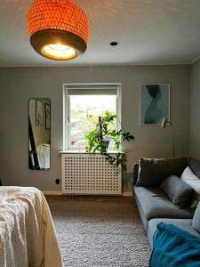 a living room with a couch and a window at House Up On Ramberget In Mollösund in Mollösund