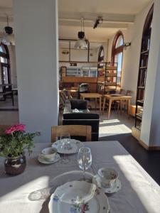 a table with two plates and wine glasses on it at 't Spoor Berlaar in Berlaar +17 photos