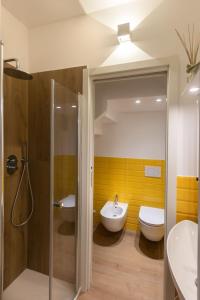 a bathroom with a shower and a toilet and a sink at Cardarelli Loft Macerata in Macerata +3 photos