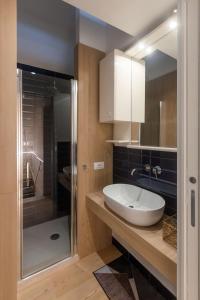 a bathroom with a white sink and a shower at Cardarelli Loft Macerata in Macerata