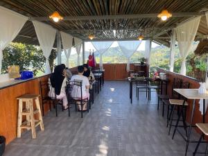 a group of people sitting at tables in a restaurant at Akimebonphuresort in Ban San Pu Loei (2)