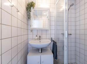 a white bathroom with a sink and a mirror at Boshuisje Rekem Charly in Lanaken +44 photos