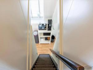a staircase leading up to a room with a stair case at Boshuisje Rekem Charly in Lanaken