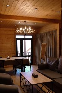 a living room with a couch and a table at Chalet Myler in Yeghipatrush