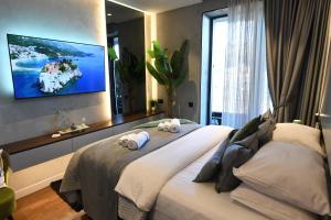 a bedroom with a large bed with two pillows on it at KRUNA 406 Apartment in Budva +46 photos