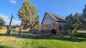 a house with a large yard with a tree at Red Wing Nest home in Redmond