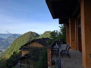 a balcony of a house with a view of mountains at Villa Thẩm mã in Dồng Văn