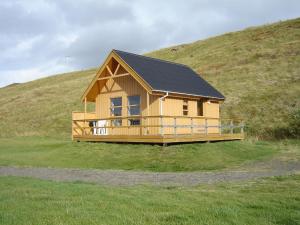 a small house on top of a hill at Dæli Apartments in Víðidalstunga