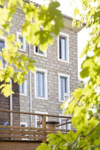 a building with a wooden fence in front of it at U Fiordalisu in Bastelica +40 photos