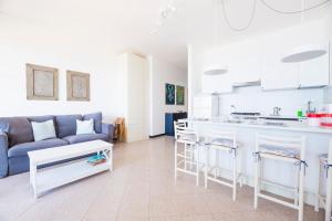 a living room with a couch and a kitchen at Facing the sea between Cinque Terre and Portofino in Deiva Marina