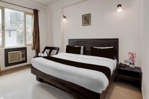 a bedroom with a large bed and a fireplace at Super Collection O Vaishno Devi Temple Formerly Hotel The Leaf in Katra