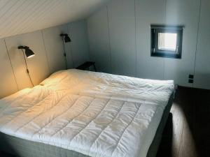 a white bed in a room with a window at Cabin In Stöten With Stunning Natural Surroundings in Stöten