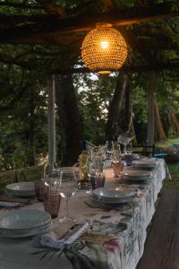 a long table with plates and glasses on it at Collina Blu - Umbria - Lago di Bolsena in Bolsena