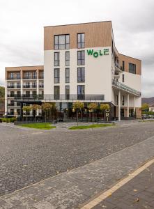 a building with a wolff sign on the side of it at WOL Green Polyana in Polyana