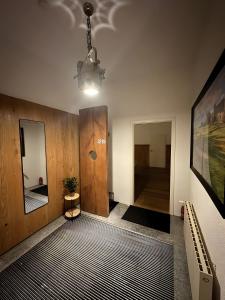 a hallway with a table and a light fixture at Ferienwohnung C und D in Oberthulba