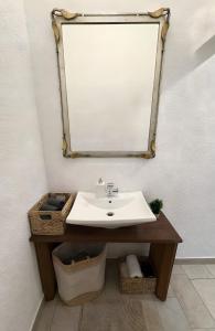 a bathroom with a sink and a mirror at Ferienwohnung C und D in Oberthulba