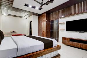 a bedroom with a bed and a flat screen tv at Townhouse Sheesh Mahal Farrukh Nagar in Farrukhnagar +22 photos