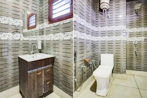 two pictures of a bathroom with a toilet and a sink at Townhouse Sheesh Mahal Farrukh Nagar in Farrukhnagar