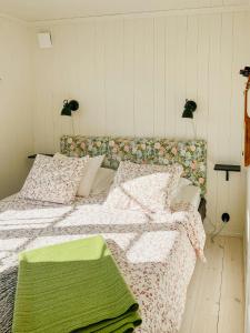 クングスハムンにあるNew Timber Holiday Home With Bay Viewsの緑の毛布が掛けられたベッドのある寝室