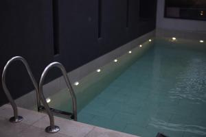 a swimming pool with a chair in the middle of a room at KRUNA 406 Apartment in Budva